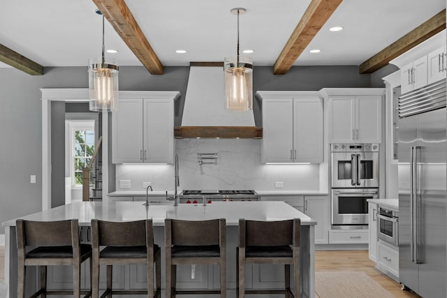 kitchen with backsplash, stainless steel appliances, custom exhaust hood, and light countertops