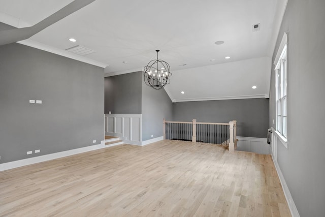 unfurnished room featuring visible vents, recessed lighting, ornamental molding, light wood-style floors, and a notable chandelier