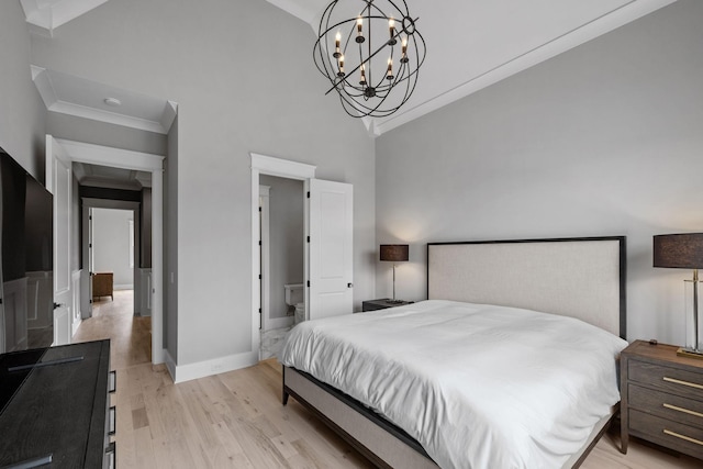 bedroom with baseboards, an inviting chandelier, a high ceiling, ornamental molding, and light wood-type flooring