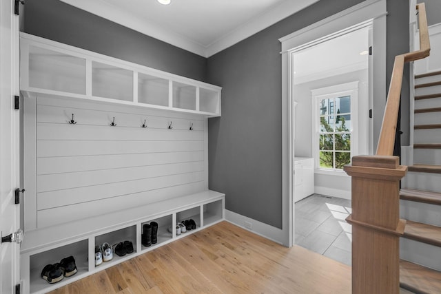 mudroom featuring crown molding, light wood-style flooring, and baseboards