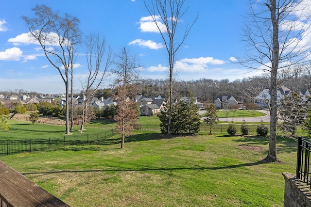 view of yard featuring a residential view and fence