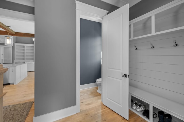 mudroom featuring beam ceiling, light wood-style flooring, and baseboards