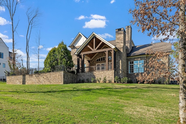 view of front of home with a front lawn and a chimney