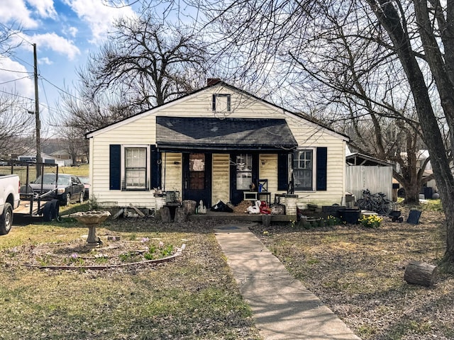 bungalow-style house featuring a porch and a chimney