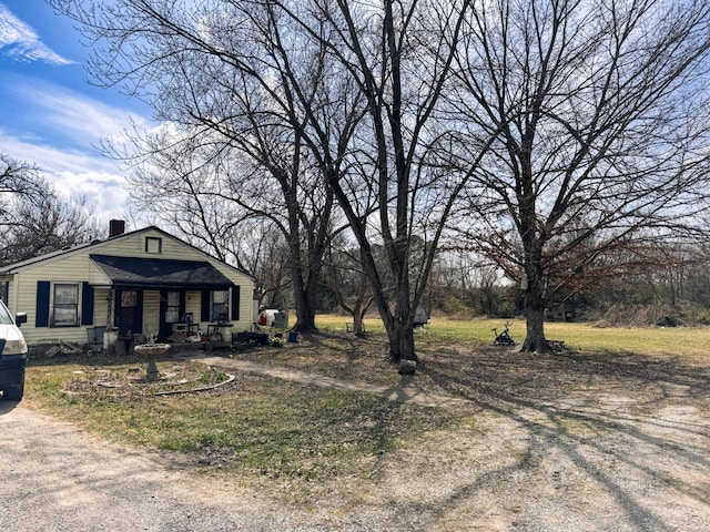 view of front of house featuring a chimney