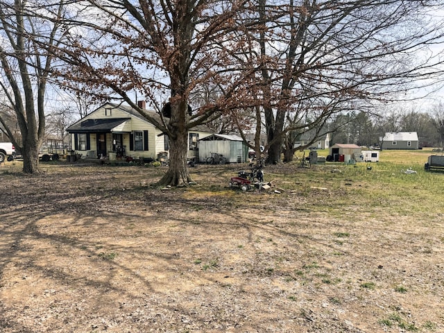 view of yard featuring an outbuilding and a porch