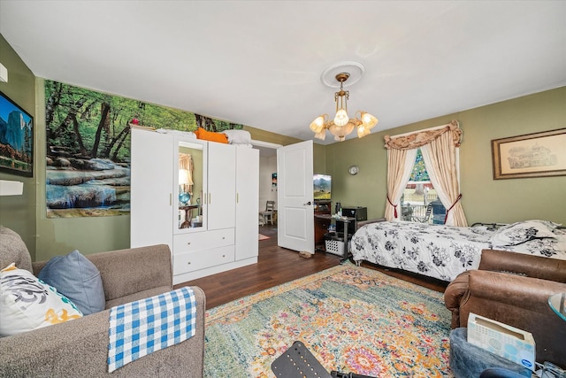 bedroom featuring a notable chandelier and wood finished floors