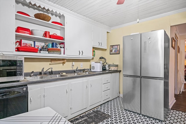 kitchen with dark countertops, ornamental molding, stainless steel appliances, white cabinetry, and a sink