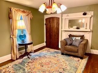 sitting room featuring wood finished floors, baseboards, and a chandelier