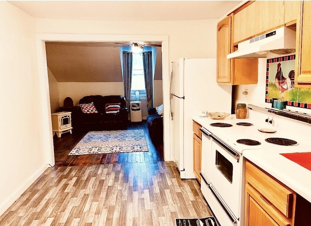 kitchen with light wood-type flooring, under cabinet range hood, white appliances, light countertops, and baseboards