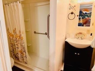 bathroom with curtained shower and vanity