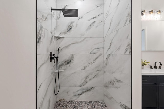 bathroom with vanity and a tile shower