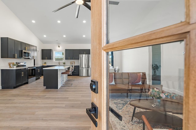 living area featuring visible vents, ceiling fan, recessed lighting, light wood-style floors, and high vaulted ceiling