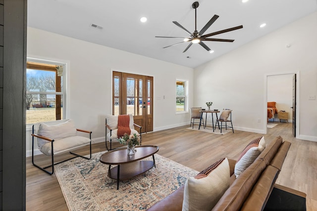 living room featuring visible vents, baseboards, recessed lighting, light wood-style flooring, and a ceiling fan