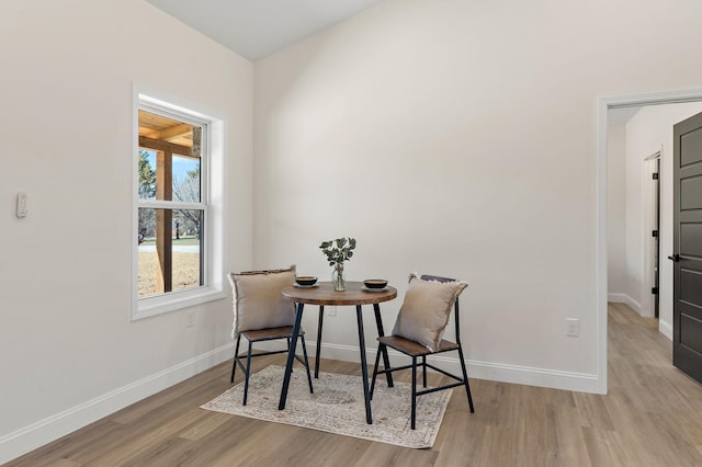 dining room featuring baseboards and wood finished floors