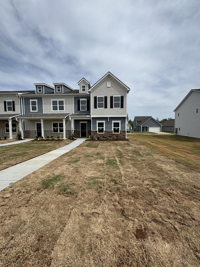view of front of house with a front lawn and board and batten siding