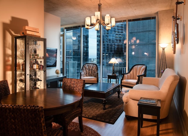 living area featuring floor to ceiling windows, wood finished floors, and a chandelier