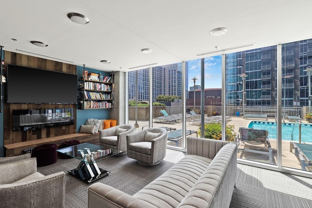 living room featuring wooden walls and expansive windows