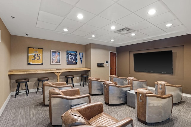 carpeted home theater room with recessed lighting, visible vents, baseboards, and a drop ceiling