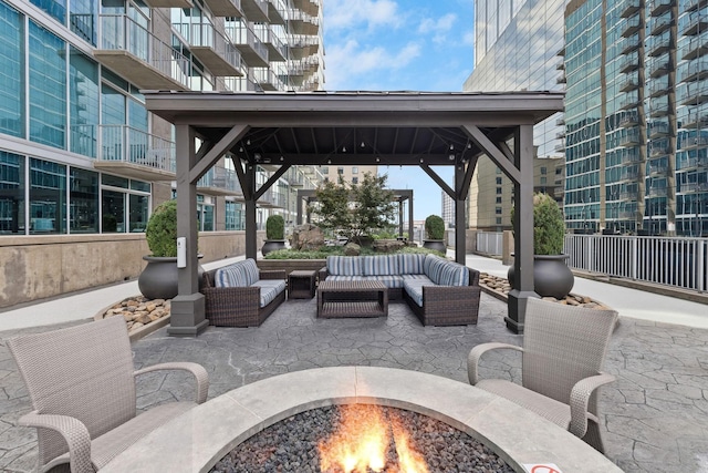 view of patio / terrace featuring an outdoor living space with a fire pit