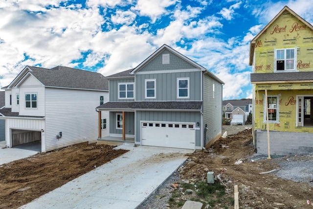 view of front of house with board and batten siding, driveway, and a garage