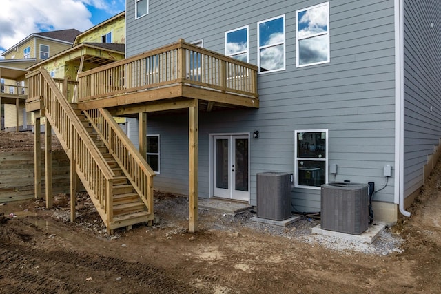 rear view of property with french doors, a wooden deck, stairs, and central AC