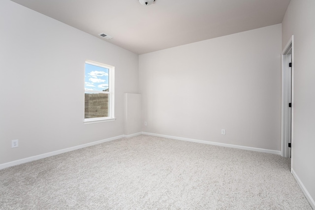 unfurnished room with visible vents, carpet, and baseboards