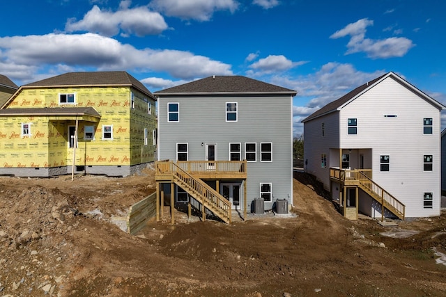 rear view of property with a deck, stairway, and central AC unit