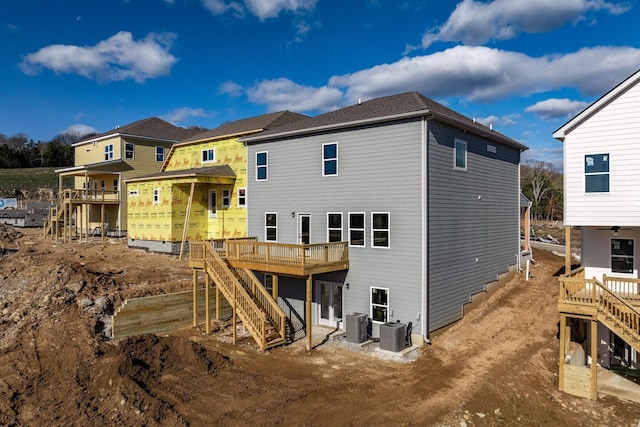 rear view of property featuring stairs, central air condition unit, and a wooden deck