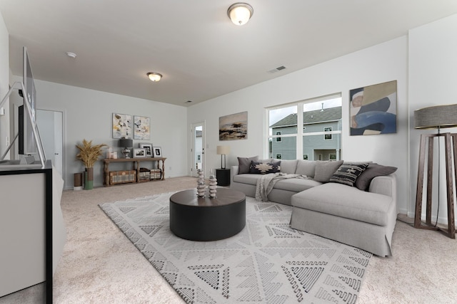 living room with visible vents and light carpet