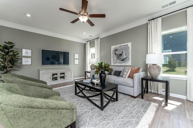 living room featuring ceiling fan, visible vents, and ornamental molding