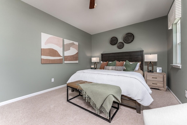 carpeted bedroom featuring baseboards and a ceiling fan