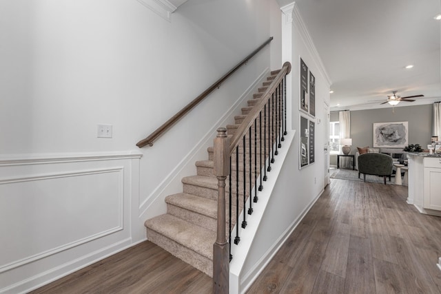 staircase with recessed lighting, wood finished floors, a ceiling fan, and ornamental molding