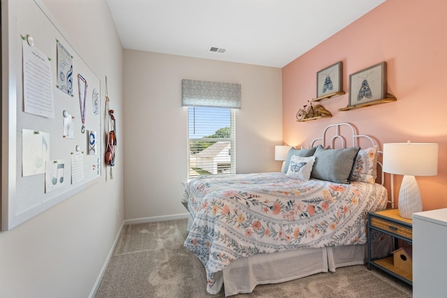 carpeted bedroom with visible vents and baseboards