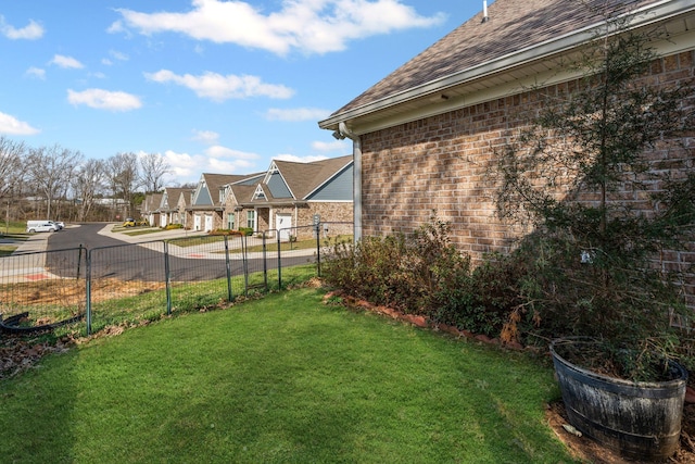 view of yard with a residential view and fence