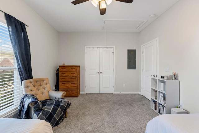 carpeted bedroom with baseboards, attic access, electric panel, ceiling fan, and a closet