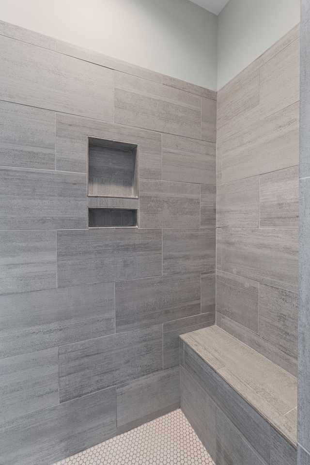 full bath featuring a tile shower