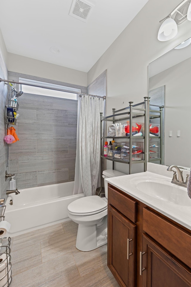 bathroom featuring vanity, shower / tub combo, toilet, and visible vents