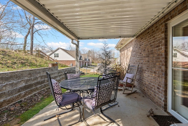 view of patio with outdoor dining area and fence