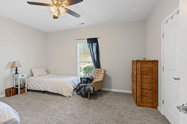 carpeted bedroom with a ceiling fan, baseboards, and visible vents