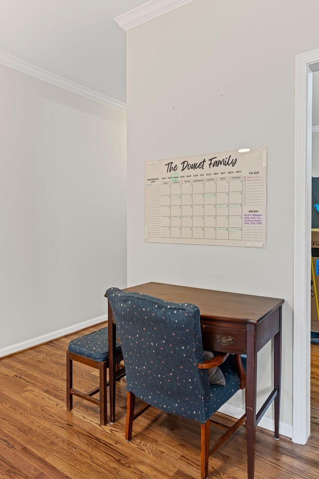 interior space featuring crown molding, baseboards, and wood finished floors