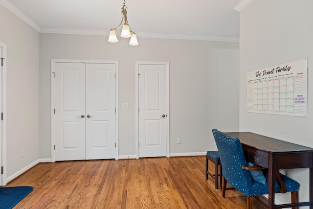 office area featuring light wood finished floors, crown molding, and baseboards