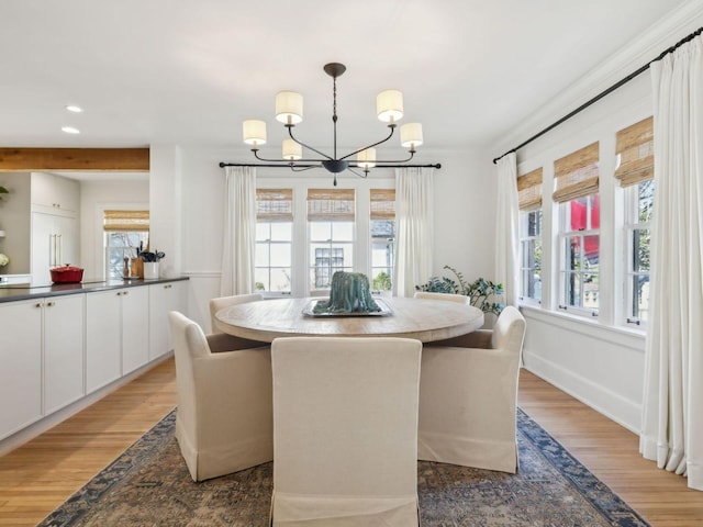 dining area featuring recessed lighting, light wood-style floors, baseboards, and a notable chandelier