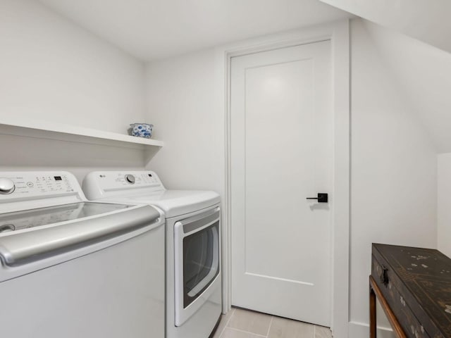 clothes washing area with washing machine and clothes dryer and laundry area