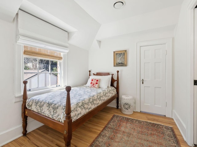 bedroom with light wood-type flooring and baseboards