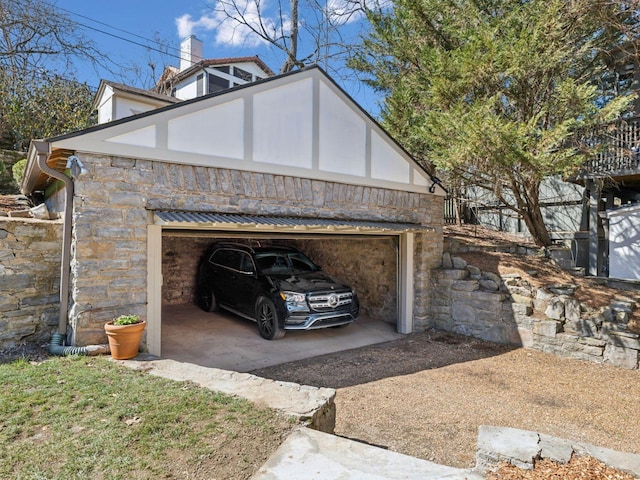 view of property exterior featuring stone siding and an outbuilding