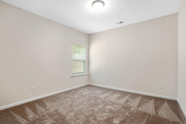 carpeted empty room with baseboards and visible vents