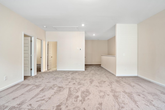 spare room featuring recessed lighting, baseboards, attic access, and carpet flooring