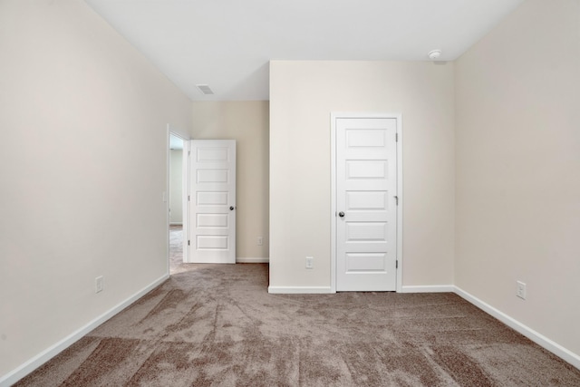 unfurnished bedroom featuring carpet flooring, visible vents, and baseboards