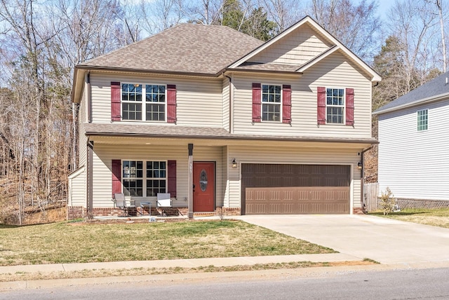 view of front of house featuring a front yard, driveway, an attached garage, covered porch, and a shingled roof